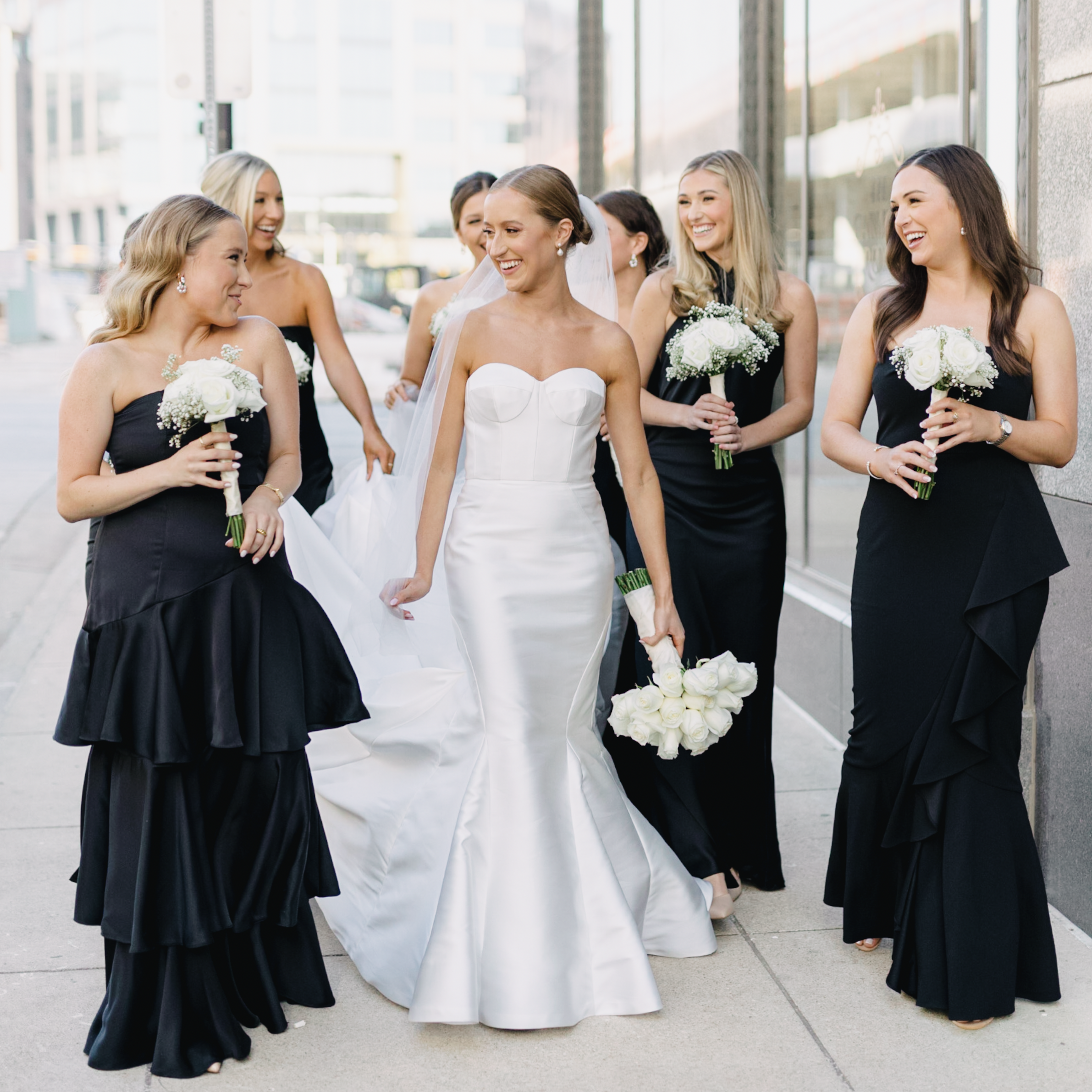 bride and bridesmaids with black dresses and bouquets